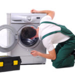 A repairman a washing machine A repairman a washing machine